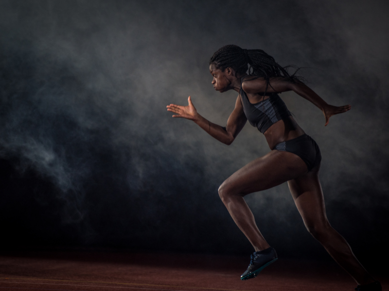 An athlete running on a track. 